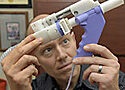 man looking at squirt gun