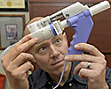 man looking at squirt gun