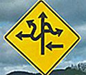 Yellow warning sign with confusing directional arrows