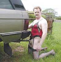 Person in red lingerie kneeling by vehicle