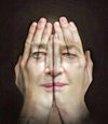 Hands pressed together forming a face illusion