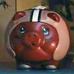 Red piggy bank wearing a racing helmet
