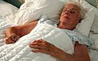 Elderly woman lying quietly in bed