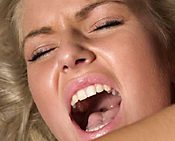 Close-up of blonde woman with mouth open