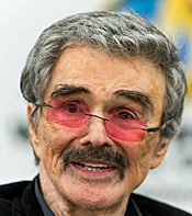 Older man with mustache wearing pink-tinted glasses