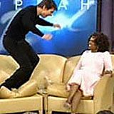 Man enthusiastically jumping on talk show couch