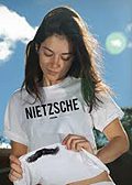 Woman adjusting Nietzsche t-shirt outdoors
