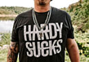 image of the country singer HARDY wearing a black T-shirt that reads "HARDY SUCKS"