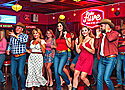 Bunch of people line dancing in a bar