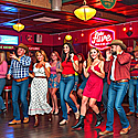 Bunch of people line dancing in a bar