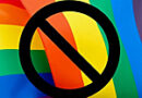 a rainbow pride flag with a black circle with a slash inside superimposed