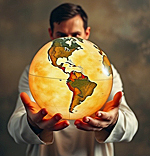 image of a young man holding a globe of the world in his hands