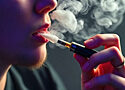close up view of a person smoking a vape pen
