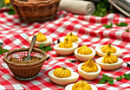 a picnic spread set out on a red-and-white checkered tablecloth