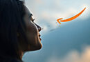 a woman's face in profile staring at the sky in which a Prime logo arrow is flying