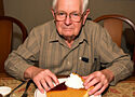 an old man eating pumpkin pie