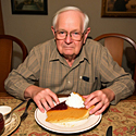 an old man eating pumpkin pie