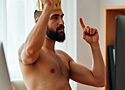 a naked man from the waist up, wearing a king's crown