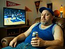 In this illustration of the NBA’s New Load Management Rules, a tired basketball fan sits in a team-decorated man cave, slumped in a worn recliner with a 24-ounce beer.