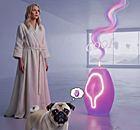 Gwyneth Paltrow wearing a neutral linen robe in a sterile, futuristic room, looking confused as a pug stares in bewilderment at a glowing, purple Goop-candle that is emitting a strange, swirling pink vapor.