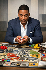 Don Lemon seated at a table playing the satirical board game Jurisdiction!, holding dice above a cluttered game board filled with authority tokens, outrage cubes, and civic power zones in a minimalist setting.