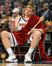 NBA Playoff Predictions: Nikola Jokic as a bored emperor on a folding chair, calmly ruling the court while chaos unfolds around him in surreal fashion.